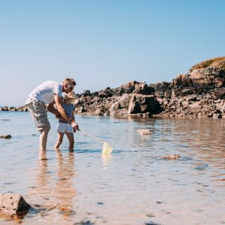 A dad and daughter playing on Green Island beach